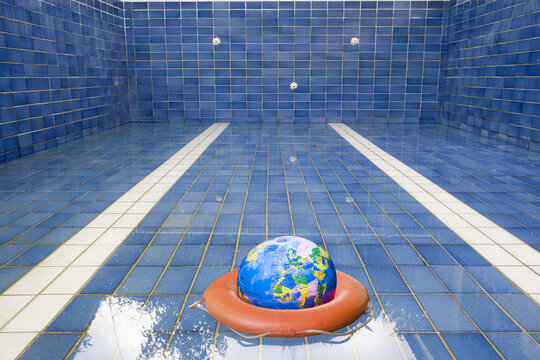 Earth and Life Preserver in Empty Swimming Pool