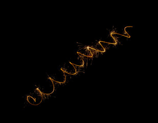 A spiral of sparklers on a black background. Festive fireworks and lights at night.