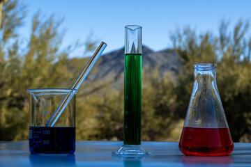 Chemicals glass containers outside in front of a mountain