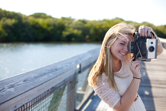 Young Woman on walkway with Camera, Palm Beach Gardens, Palm Beach County, Florida, USA