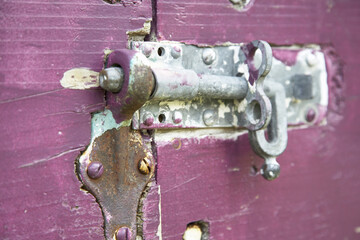 Close-Up of Sliding Bolt Lock on Purple Gate