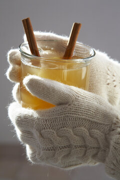 Close-up of Woman Holding Mug of Apple Cider With Cinnamon Sticks