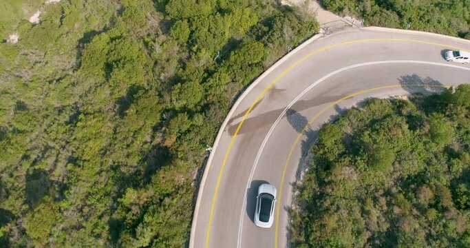 Aerial view of a sport car driving in a woodland, Carmel Forest, Haifa, Israel