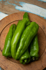 Portion of green peppers on wooden dish