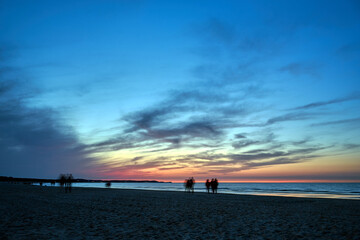 sunset on a sandy beach by the Baltic sea in the evening