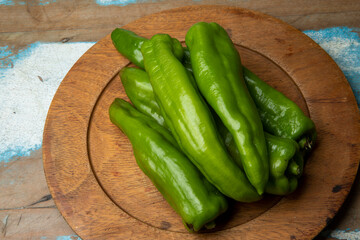 Portion of green peppers on wooden dish