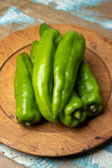 Portion of green peppers on wooden dish