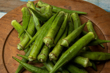 Portion of okra on wooden plate. Brazil