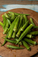 Portion of okra on wooden plate