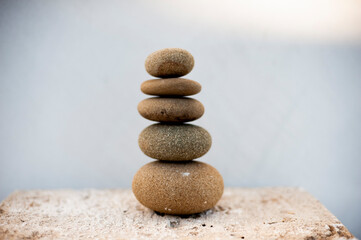 Fototapeta na wymiar River stones stacked on a stone table top. Still Life Photography. 