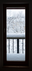 Fototapeta na wymiar Looking through window from indoor to outdoor. Major snowfall. Everything covered under snow. Winter weather.