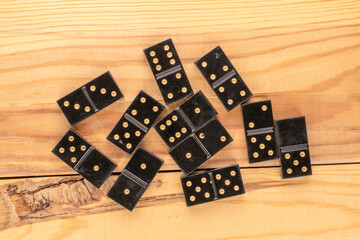 Several dominoes on a wooden table, macro, top view.