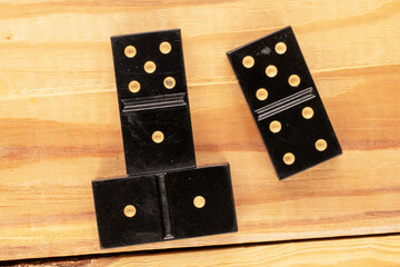 Several dominoes on a wooden table, macro, top view.
