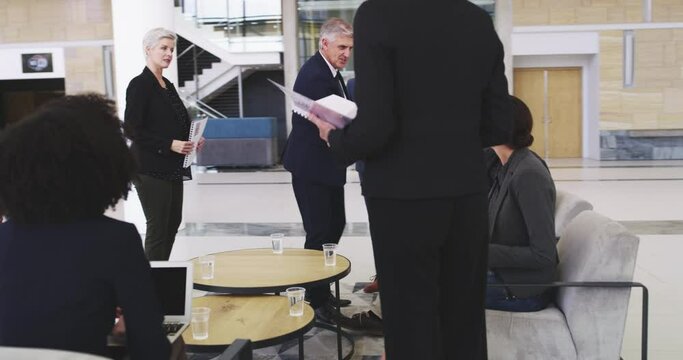 Handshake, greeting and business people meeting in a convention center for a conference or workshop. Tradeshow, hand shake and boss meeting diverse staff before a presentation on strategy