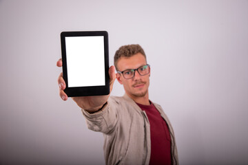 A man shows the blank screen of his tablet, advertising photo with mock up.