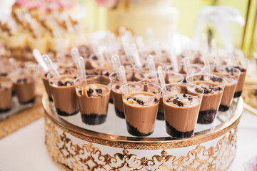 coffee desserts on a table for the celebration of a first communion with abundant decoration