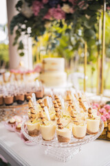 tiramisu desserts on a first communion celebration table with abundant decoration, vertical
