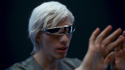 Impressed vr headset man enjoying augmented reality closeup. Gamer touching arms