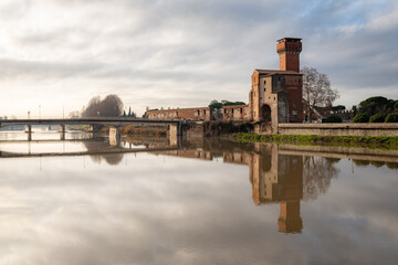 The Torre Guelfa (Guelph Tower) near the Arno river is a tower of Pisa in the Cittadella, which dates back to the mid-15th century. - obrazy, fototapety, plakaty