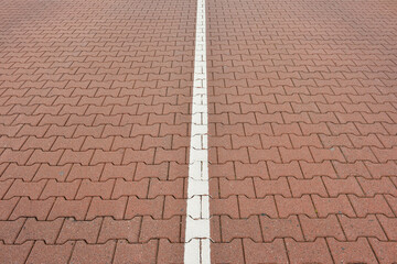 Close-up of road with interlocking brick stones and white line, Norderney, East Frisia Island, North Sea, Lower Saxony, Germany