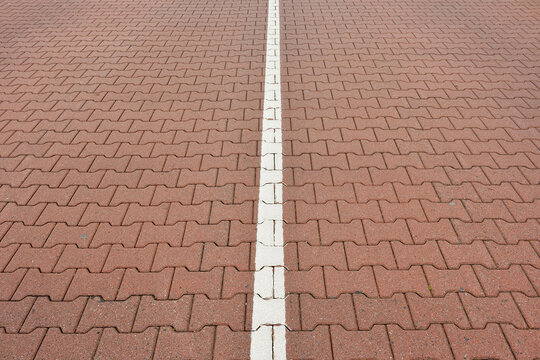 Close-up of road with interlocking brick stones and white line, Norderney, East Frisia Island, North Sea, Lower Saxony, Germany