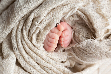 Close-up of unrecognizable cute baby shaking feet while lying in bed, innocence concept