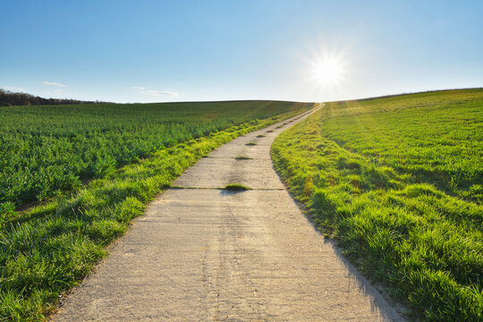 Road through Field with Sun, Helmstadt, Franconia, Bavaria, Germany
