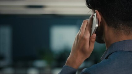 Back rear view unknown male businessman young man entrepreneur HR manager boss talk mobile phone in office calling distant client use cell communication speak telephone wireless business conversation - Powered by Adobe