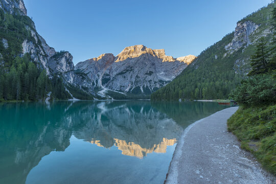 Lakeside path with Croda del Becco (Seekofel) reflected in Braies Lake (Lago di Braies) in the Bolzano Province (South Tyrol) Dolomites, Italy