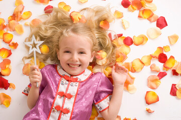 Little Girl with Magic Wand Lying Amongst Flower Petals