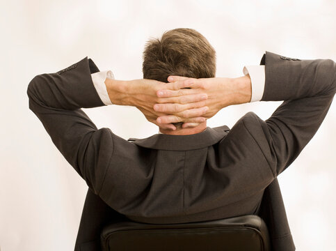 Businessman with Hands Behind Head
