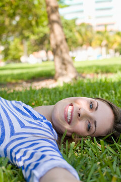 Woman Lying on Grass, Miami Beach, Florida, USA