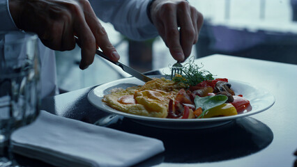 Unrecognizable man having elegantly served delicious meal in stylish restaurant