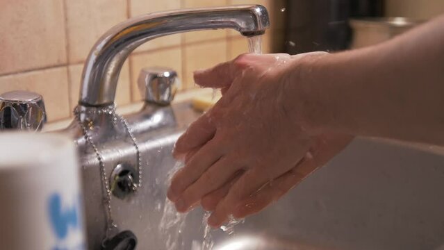 Washing hands under kitchen tap Slow-Motion