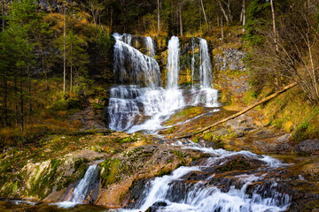 Fototapeta na wymiar Autumn landscape with Gletschergarten waterfall in Bayern, Germany