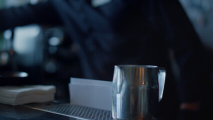 Barista hands serving coffee for client closeup. Barman putting plate spoon