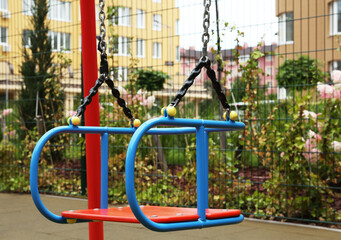 Fototapeta na wymiar Swing on outdoor playground in residential area