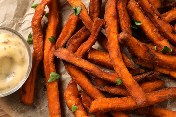 Delicious sweet potato fries and sauce, closeup