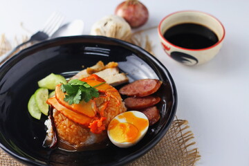 Barbecued red pork in sauce with rice served in the restaurant. There are many sold in Thailand.Barbecued red pork in sauce with rice is a popular food in Thailand.