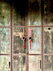 old wooden door with rusty metal door handles