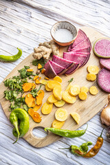 Colorful vegetables ready to use on a cutting board - healthy vegan and vegetarian lifestyle flat lay