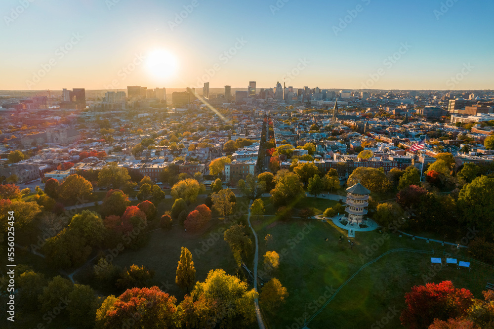 Wall mural aerial drone view of patterson park in baltimore city in fall at sunset with the city skyline in the