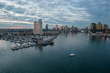 Aerial Drone View of Baltimore City Apartment Complex along the Water at Sunset with Boats Docked...