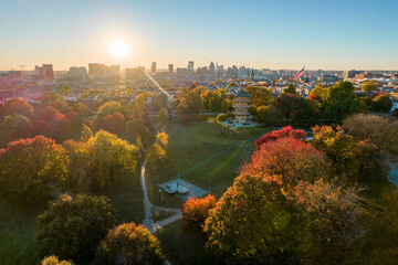 Aerial Drone View of Patterson Park in Baltimore City in Fall at Sunset with the City Skyline in...