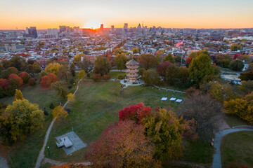 Aerial Drone View of Patterson Park in Baltimore City in Fall at Sunset with the City Skyline in...