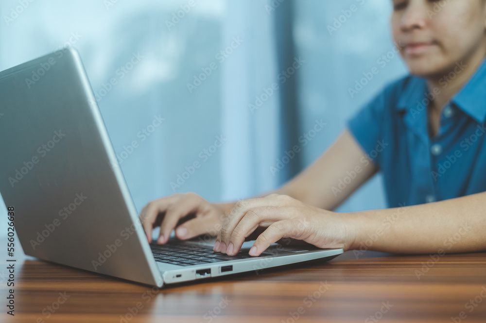 Poster people using computer side view of male hands typing on laptop keyboard