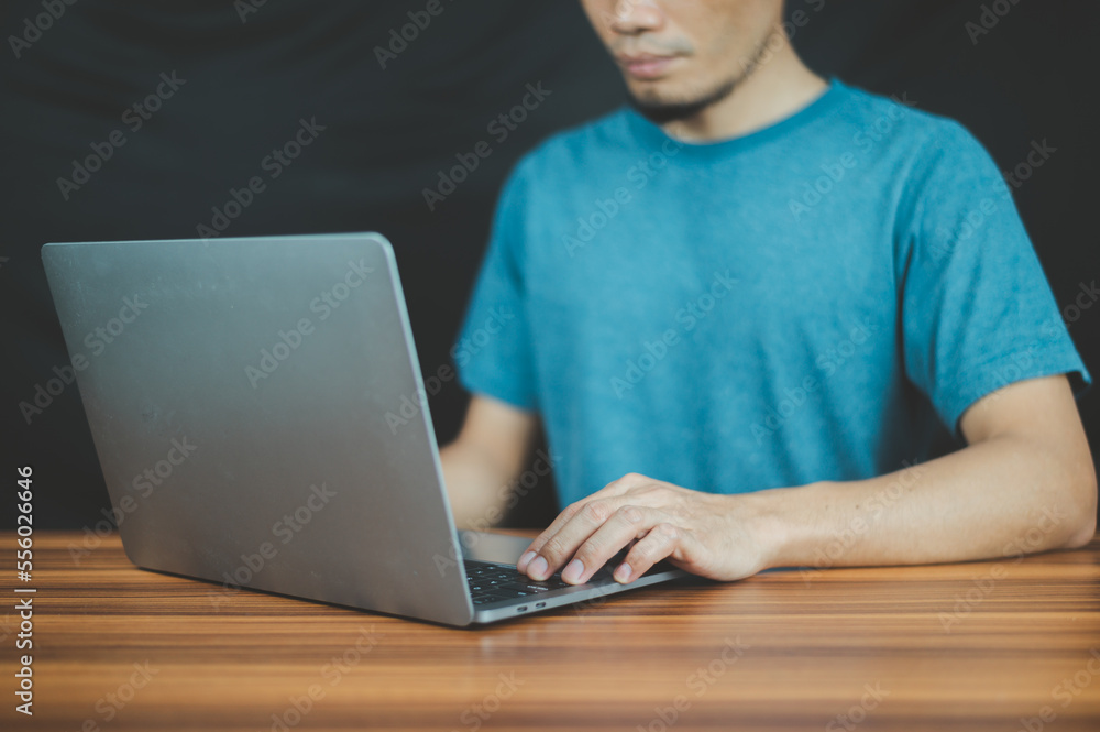 Poster people using computer side view of male hands typing on laptop keyboard