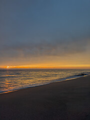 Fototapeta premium Beautiful sunrise on the Atlantic Ocean. Photo of the ocean. Background. Vertical photo. Soft focus