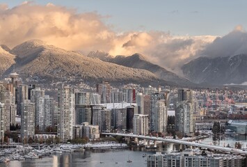 View of Vancouver and Cambie Bridge with mountains covered with snow in the morning light. Yaletown. British Columbia. Canada