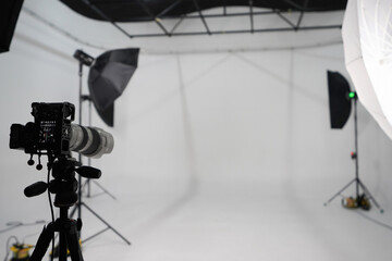 An empty photo Studio with white cyclorama. Monoblocks with flashes using softboxes of different...